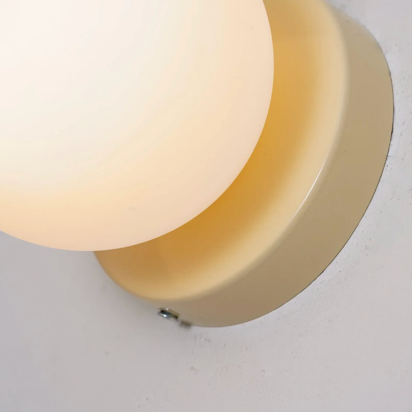 A modern wall sconce with a spherical shade – a minimalist design for interiors 8