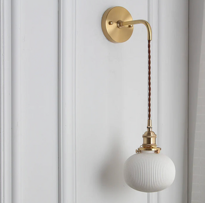 Retro-style wall sconce with a frosted shade and brass finish 8