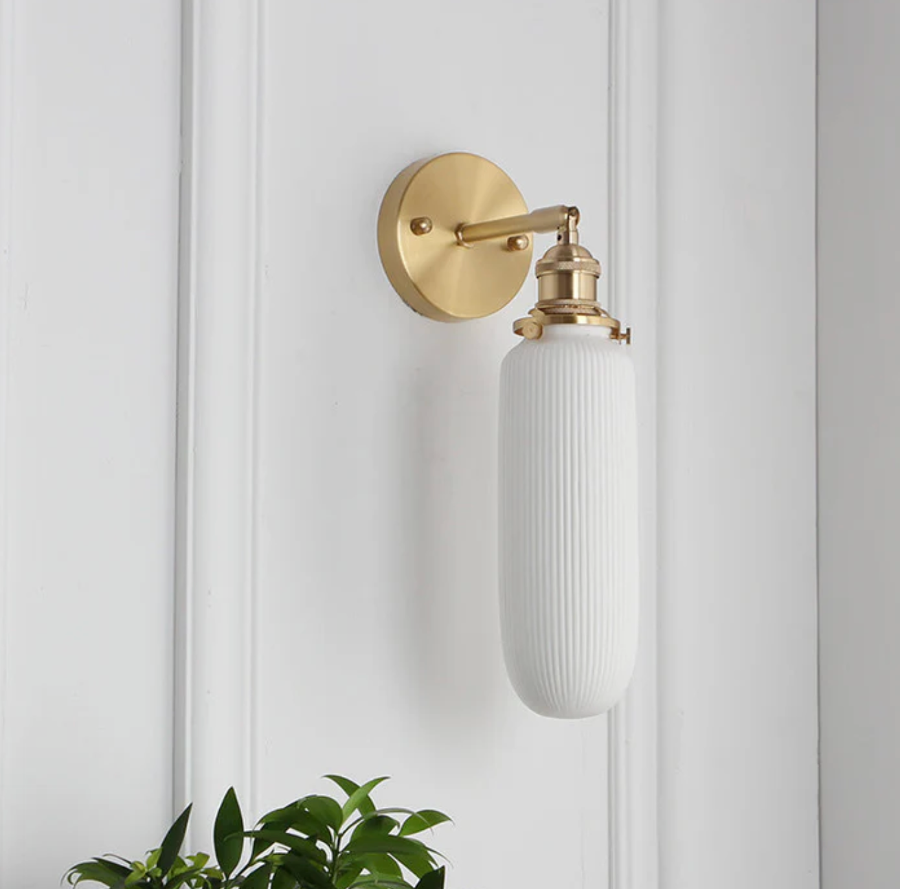 Retro-style wall sconce with a frosted shade and brass finish 10