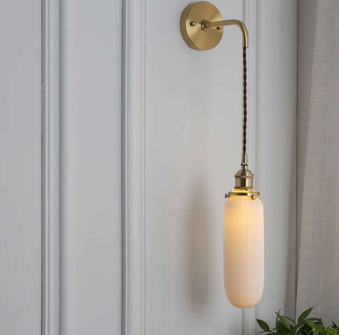 Retro-style wall sconce with a frosted shade and brass finish 11