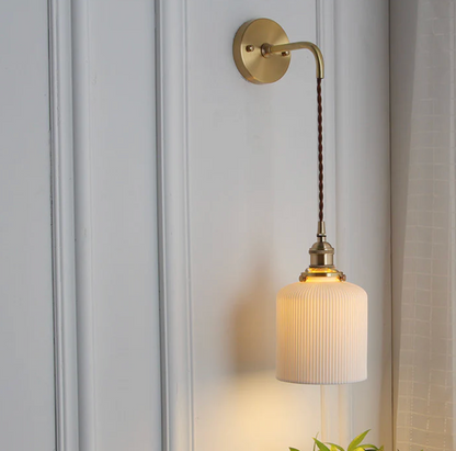 Retro-style wall sconce with a frosted shade and brass finish 12