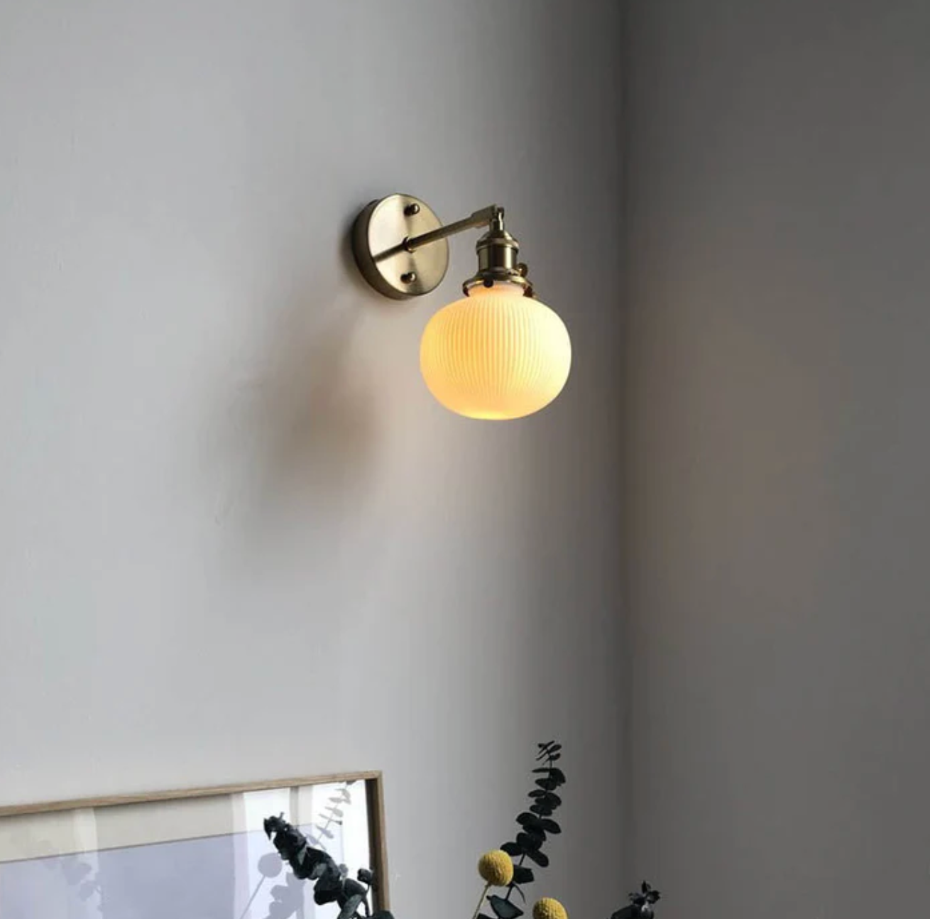 Retro-style wall sconce with a frosted shade and brass finish 13