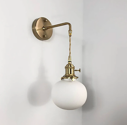 Retro-style wall sconce with a frosted shade and brass finish 3