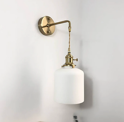 Retro-style wall sconce with a frosted shade and brass finish 5