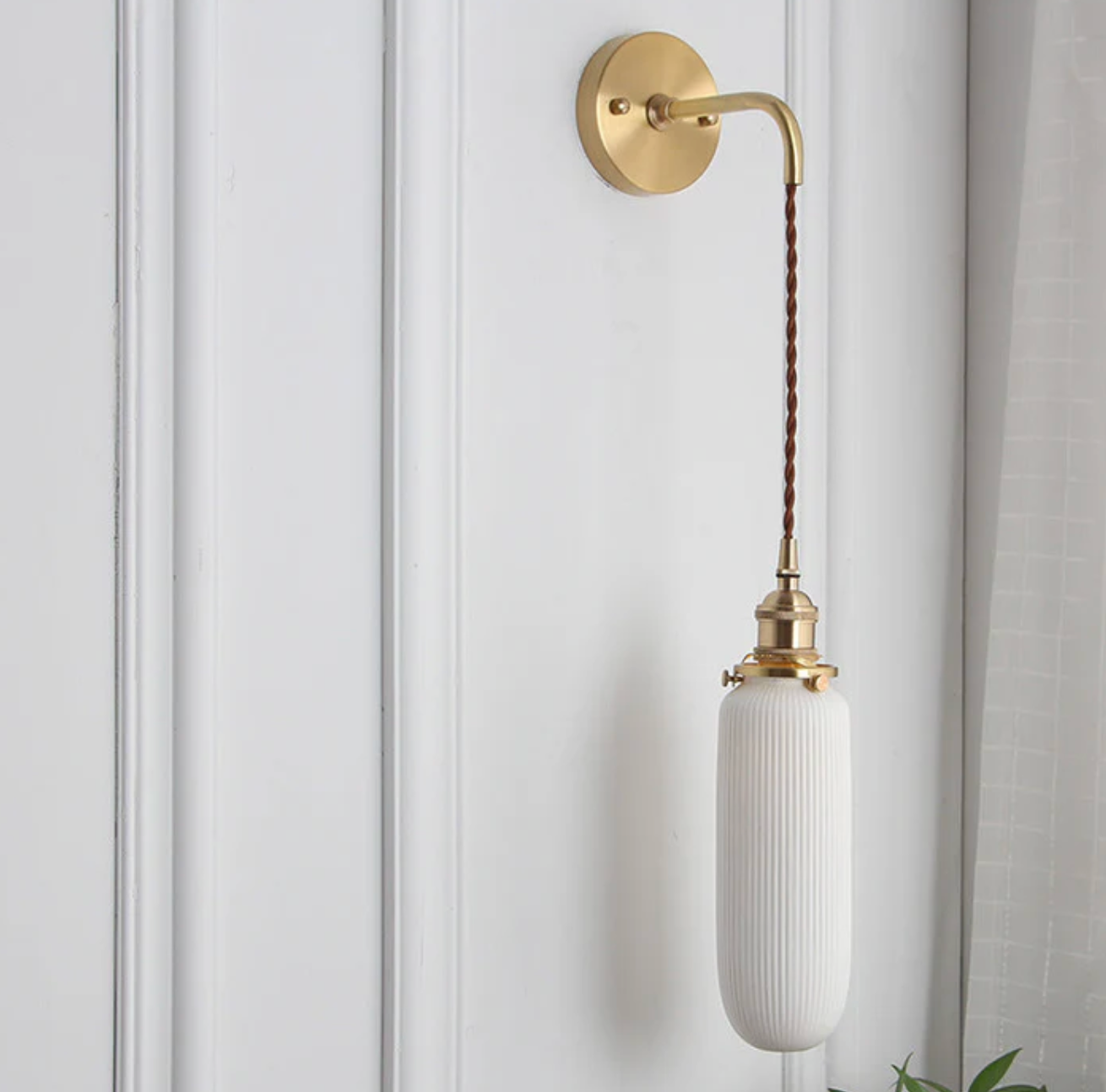 Retro-style wall sconce with a frosted shade and brass finish 7