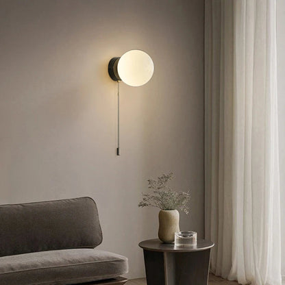 Wall sconce with a spherical shade and chain – modern elegance in a minimalist form 1