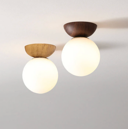 A ceiling or pendant lamp with a frosted shade and a wooden accent – minimalist elegance for any interior 1