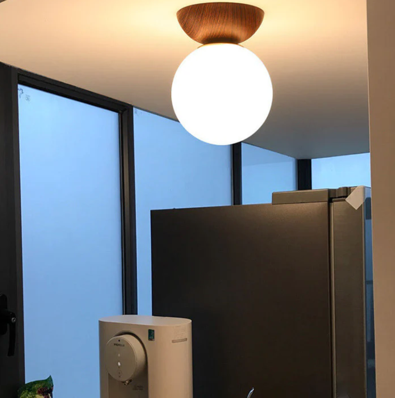 A ceiling or pendant lamp with a frosted shade and a wooden accent – minimalist elegance for any interior 5