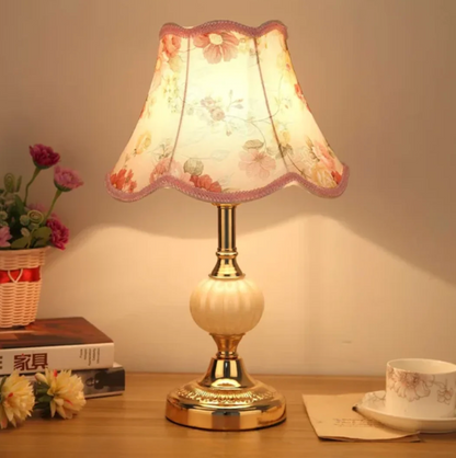 A classic table lamp with a decorative lampshade – an elegant bedside lamp in a retro style. 0